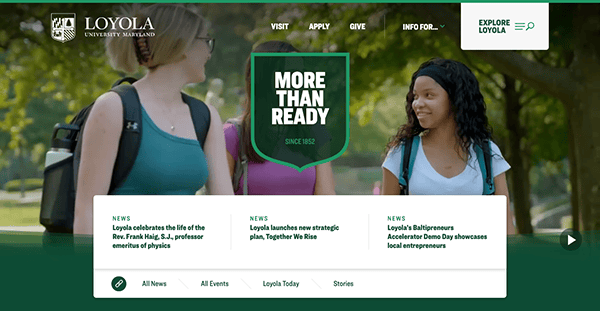 Two students walking and chatting on the loyola university maryland campus, with a "more than ready" banner overhead and website navigation menu.