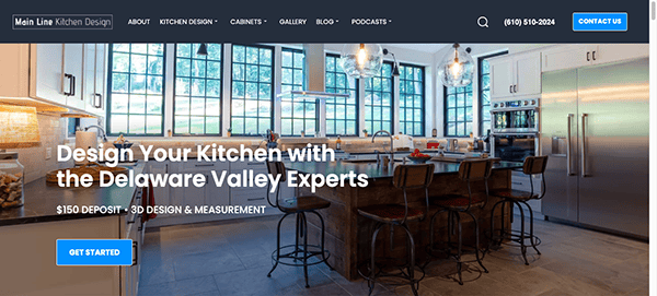 A modern kitchen showroom with bar stools at a large island, stainless steel appliances, and large windows. Text reads "Design Your Kitchen with the Delaware Valley Experts.
