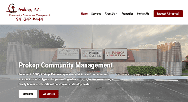 Homepage of Prokop Community Management website featuring a header with company logo, navigation menu, and a phone number, with an image of the business storefront in the background.