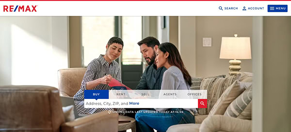 Real estate agent discussing documents with a couple in a well-lit living room, with re/max website interface overlay at the top.