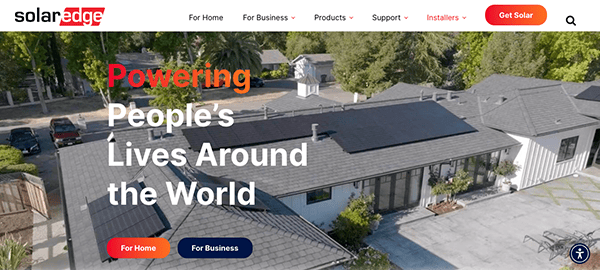A house with solar panels on the roof is shown. The text reads, "Powering People’s Lives Around the World." The image is from a SolarEdge webpage with navigation links and a call to action button for getting solar.