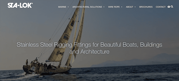 A sailboat with several crew members on the water, under a clear sky, promoting sta-lok's stainless steel rigging fittings.