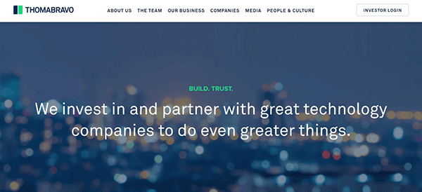 Website homepage of Thoma Bravo featuring a blurred cityscape background with a clear text overlay stating, "We invest in and partner with great technology companies to do even greater things.