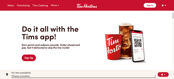 A tim hortons promotional webpage featuring an iced beverage, a red cup, and a smartphone displaying the tim's app, with text encouraging app sign up for order and points benefits.