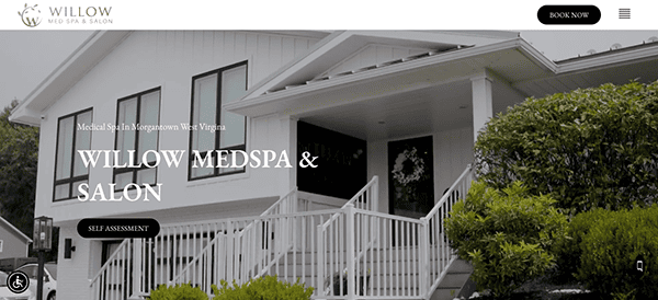 Front view of Willow Medspa & Salon building with a white facade and a porch, surrounded by greenery, featuring a website overlay with location details.
