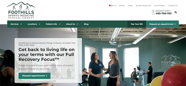 People exercising at a physical therapy clinic. A large banner promoting Foothills Sports Medicine Physical Therapy highlights their Full Recovery Focus™ program. Contact details and navigation menu are visible.