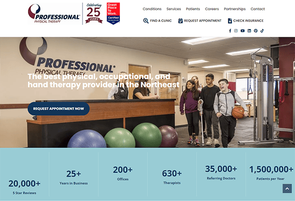 A group of people are at a physical therapy clinic. Large exercise balls and therapy equipment are in the background. The screen shows business accolades and contact options.