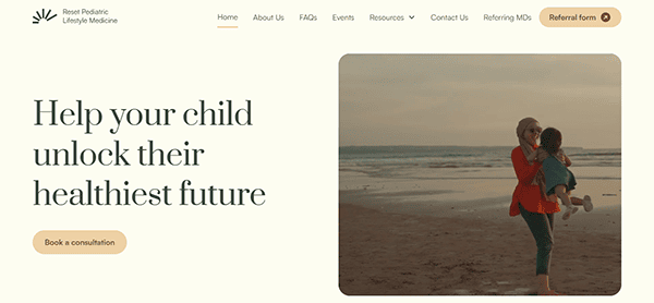 A woman on a beach holding a child with a text overlay reading, "Help your child unlock their healthiest future." There are navigation links and a button labeled "Book a consultation.