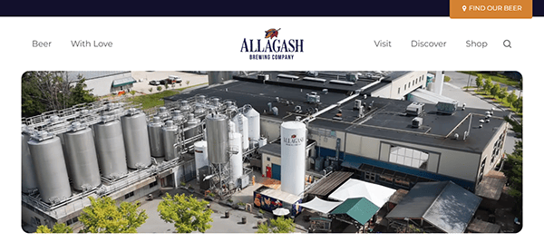 Aerial view of Allagash Brewing Company with large tanks and surrounding facilities, capturing a sense of craftsmanship that inspires top-tier Brewery Websites.