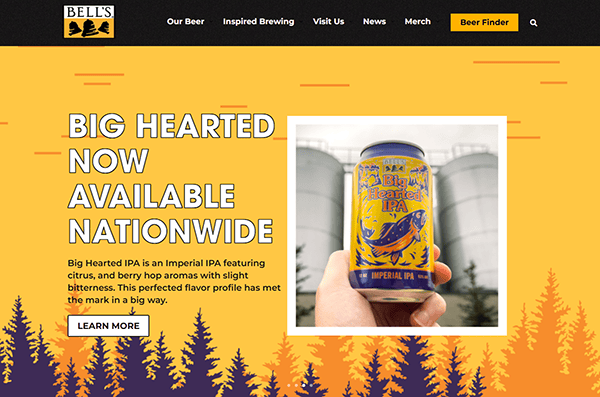 Bell's Brewery website shines as one of the best brewery websites, featuring an announcement for the Big Hearted IPA. Showcasing the can with citrus and berry hop aromas against a yellow background, it highlights the beer's nationwide availability.