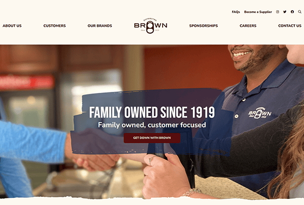 People shaking hands beneath a "Family Owned Since 1919" banner, showcasing their trust. A man in a "Brown" branded shirt highlights the personal touch you expect on premium beverage distributor websites. Navigation bar and company logo proudly displayed at the top.