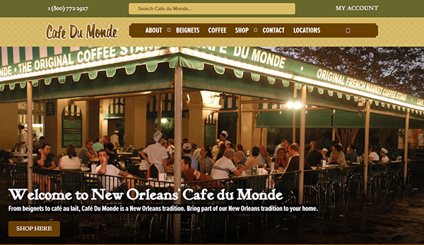 Under a green and white awning, the nighttime ambiance of Café Du Monde comes alive with diners enjoying their moments. This iconic spot, celebrated among the 20 Best Cafe Websites, invites everyone to experience its charming outdoor seating area.