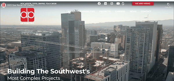 A cityscape highlights a crane among towering buildings. The text reads, "Building The Southwest's Most Complex Projects." DP Electric, known as the Best Commercial Electrician, is prominently branded at the top.