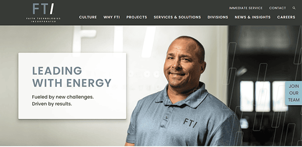 A man proudly wearing an FT shirt smiles at the camera. Text on image reads: "Leading with Energy. Fueled by new challenges. Driven by results." FTI Technologies branding visible, embracing the spirit of a best commercial electrician in every endeavor.