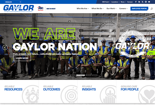 A group of workers in safety gear poses indoors beneath a banner that proudly reads "We Are Gaylor Nation." The top showcases Gaylor Electric branding and navigation menu, embodying the essence of the best commercial electrician websites.