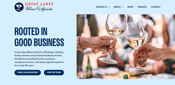 Three people toast with wine glasses on the Great Lakes Wine & Spirits webpage, a premier beverage distributor website, highlighting their business history and values.