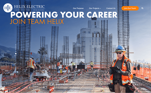 Construction workers in safety gear navigate the building site with steel frameworks, crafting the future under a clear sky. The cityscape stretches beyond, a dynamic backdrop that might soon feature structures serviced by the best commercial electrician experts.