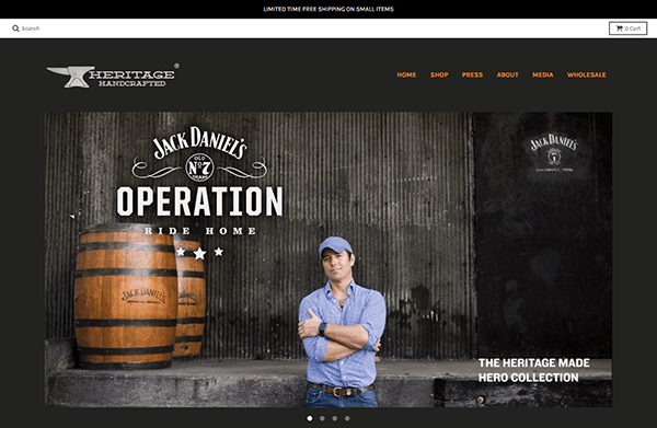 A man stands with arms crossed in front of a large wooden barrel, echoing the craftsmanship of a seasoned carpenter, as he promotes Jack Daniel's Operation Ride Home on a dark-themed website.