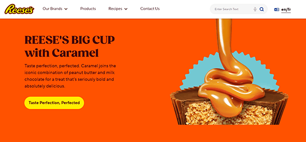 Reese's Big Cup with Caramel ad showcases a delectable peanut butter cup enhanced by rich caramel. Set against a vibrant orange background, it touts the new flavor, enticing candy enthusiasts to explore more on popular candy websites.