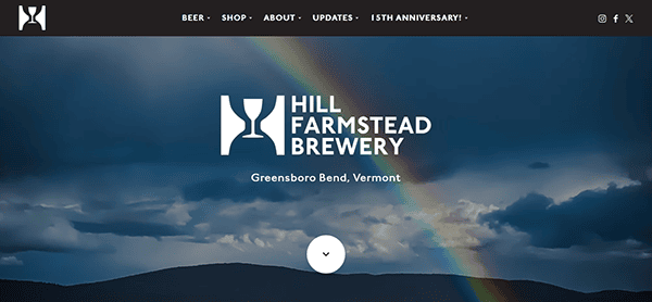 Logo and text for Hill Farmstead Brewery, Greensboro Bend, Vermont, grace a scenic backdrop with a rainbow and cloudy sky. Renowned as one of the best brewery websites, the header offers seamless navigation options.