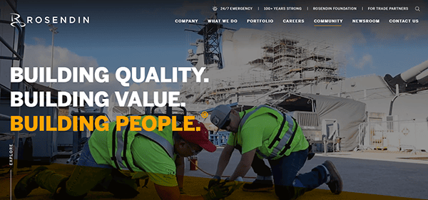 Workers in safety gear crouch on a construction site with industrial equipment in the background, embodying the dedication and precision showcased on commercial electrician websites.
