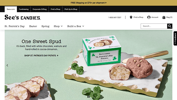 See's Candies' webpage, one of the best candy websites, showcases St. Patrick's Day potato-themed treats with chocolate and walnuts, elegantly displayed on a marble tray adorned with decorative shamrocks.