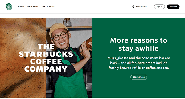 A Starbucks barista smiles while holding a coffee pot. Text beside him promotes reasons to visit, including mugs, glasses, and a condiment bar for refills on coffee and tea—just like the offerings highlighted on the best cafe websites.