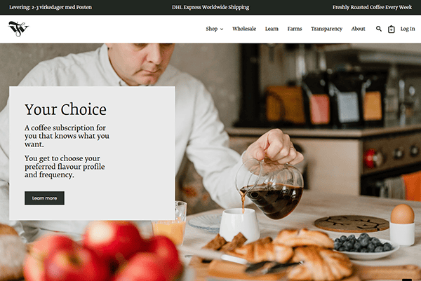 Person pouring coffee from a carafe into a cup on a table with a breakfast spread, including pastries and fruits. Overlay hints at cafe website designs showcasing customizable coffee subscriptions, blending digital innovation with your morning routine.