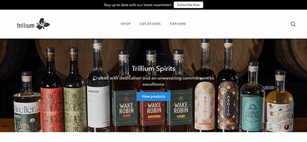 Display of various bottles of Trillium Spirits on a shelf with a banner promoting their quality, capturing the essence you'd find while exploring the best brewery websites.