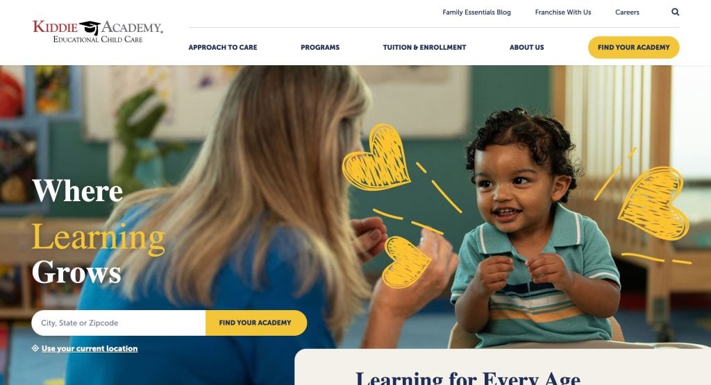 A woman smiles and interacts with a cheerful toddler in a classroom setting. Yellow doodle hearts highlight the joyful moment. Text reads “Where Learning Grows.” This scene showcases inspiration for the best daycare websites. Search and navigation menus are visible.