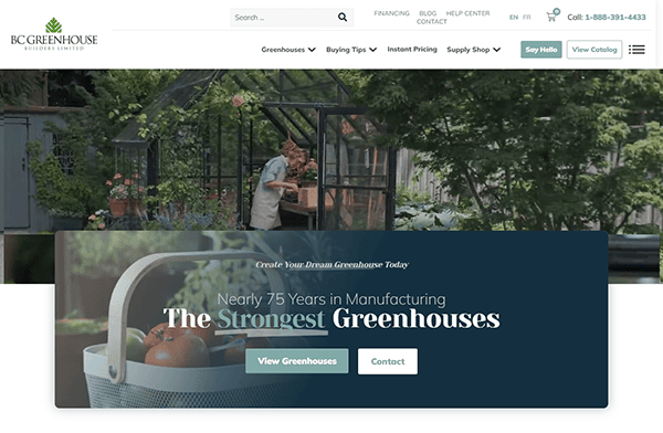 A person tends to plants in a glass greenhouse. A banner reads: "Nearly 75 Years in Manufacturing The Strongest Greenhouses." Discover the best greenhouse design and more on top greenhouse websites with options to "View Greenhouses" and "Contact" provided.