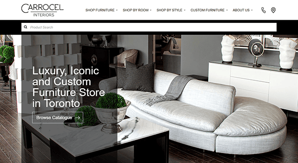 Modern living room featuring a curved gray sofa, black coffee table, decorative pillows, and stunning art pieces. Text overlay: "Luxury, Iconic and Custom Furniture Store in Toronto—your destination for the best furniture websites.
