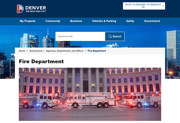 Fire trucks parked in front of a building on the Denver Fire Department's esteemed website at night, showcasing one of the best fire department scenes.