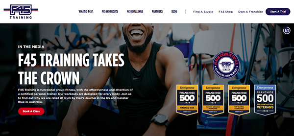 F45 Training's webpage, one of the best gym websites, proudly displays its awards and a man's smiling face, embodying their fitness success.
