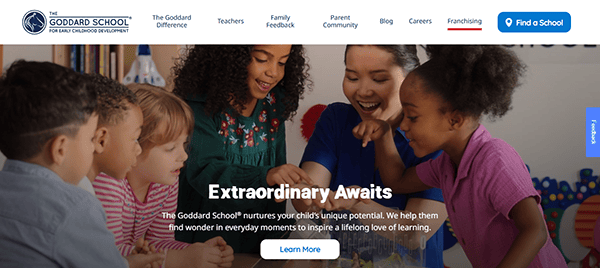 Children gathered around a table with colorful blocks, guided by a teacher. Text reads: "Extraordinary Awaits at the Best Daycare" with a button labeled "Learn More" below.