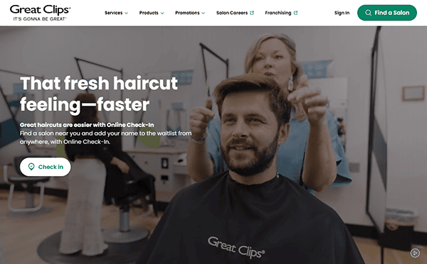 Man with barber cape in salon chair, hair stylist behind him, in a Great Clips salon. Text highlights online check-in for the best hair stylists, simplifying your visit.