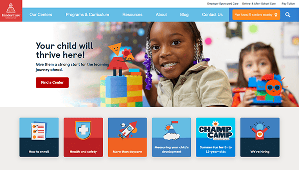 A child sits at a table with colorful blocks and a paper robot in a KinderCare ad. Explore the eight buttons below for information about centers, safety, and programs on one of the best daycare websites.
