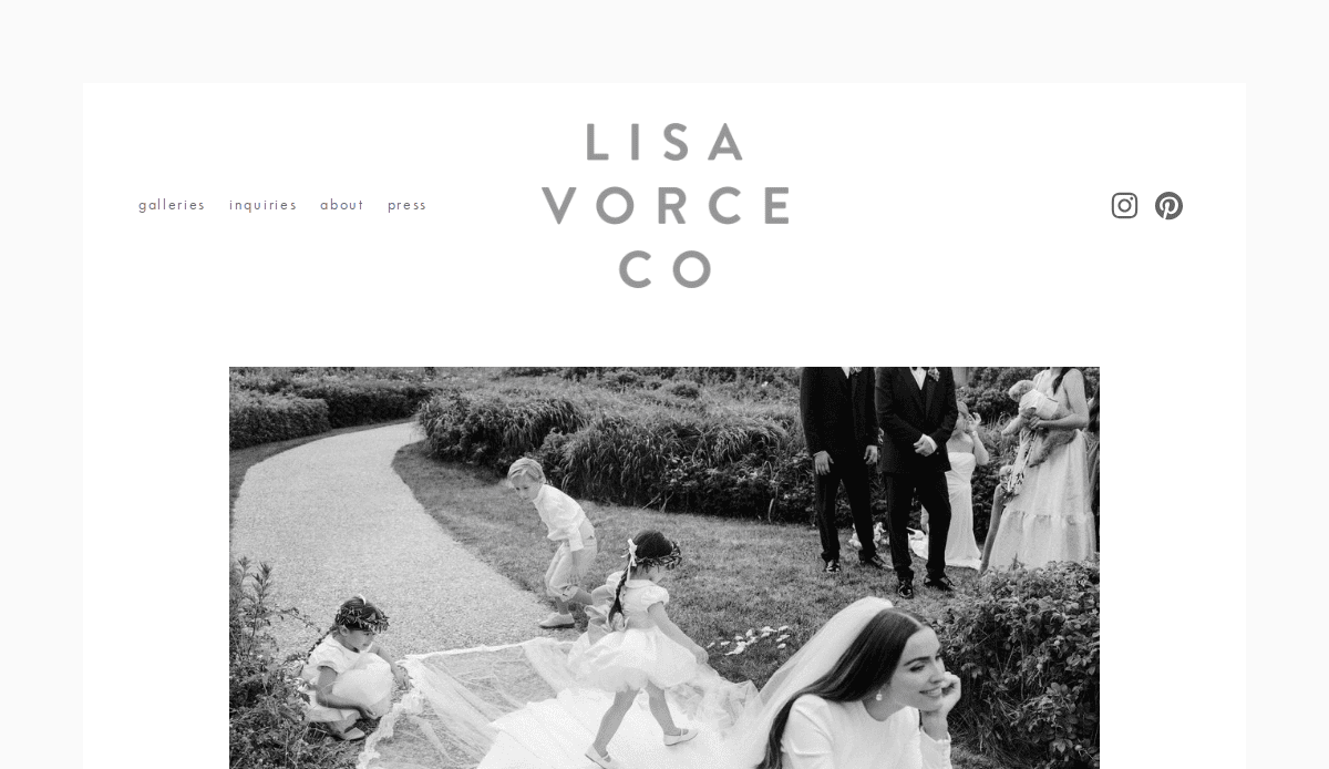 Black and white photo of children playing on a garden path during a wedding, with a bride smiling in the foreground and other guests behind. The website header reads Lisa Vorce Co., an inspiring example among top event planners websites.