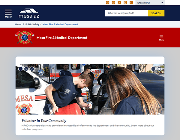 Two volunteers from the Mesa Fire & Medical Department, wearing department T-shirts, assist at an outdoor community event. Their involvement highlights the unity and dedication you'd expect from a team featured on the best fire department websites.