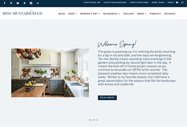 A website screenshot showcases a home kitchen with a wooden island, rustic decor, and large windows. The text on the right welcomes spring, diving into seasonal changes and home projects. Discover inspiration and tips on the best furniture websites for your refreshing needs.
