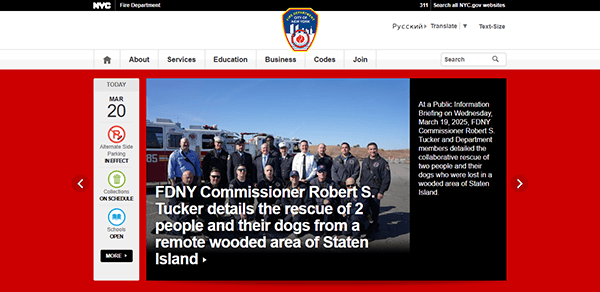 FDNY Commissioner and team stand proudly in front of a fire truck. The display screen reads March 20, with text on the right detailing a heroic rescue of two people and their dogs from wooded Staten Island, showcasing why they are featured on the best Fire Department Websites.