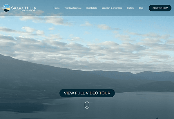 The homepage showcases a scenic view of hills and a lake under a cloudy sky, perfectly blending tranquility with modern design. Navigate easily through commercial real estate websites or click the "Register Now" button for seamless access.
