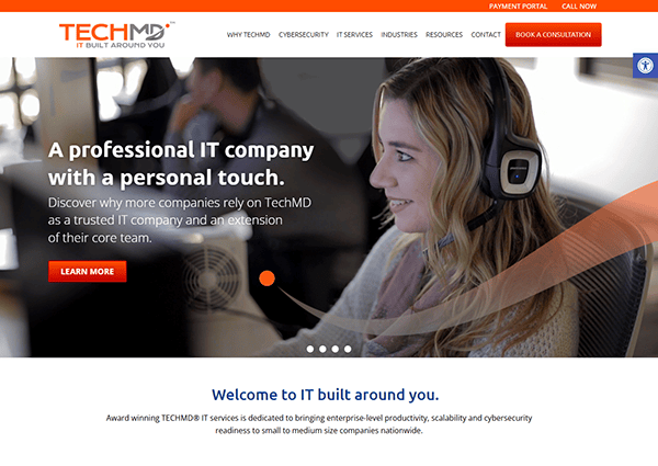 A woman wearing headphones works on a computer, illustrating TechMD as an IT company focused on providing the best tailored services.