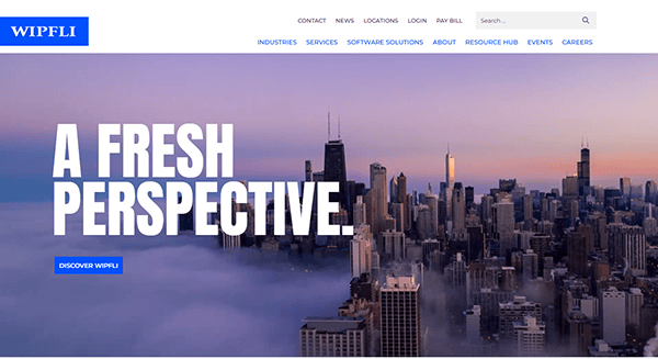 City skyline with tall buildings rising above clouds, accompanied by the text "A Fresh Perspective" and "Discover Wipfli" on the left. Showcasing one of the best CPA websites, WIPFLi's logo is prominently featured in the top left corner.