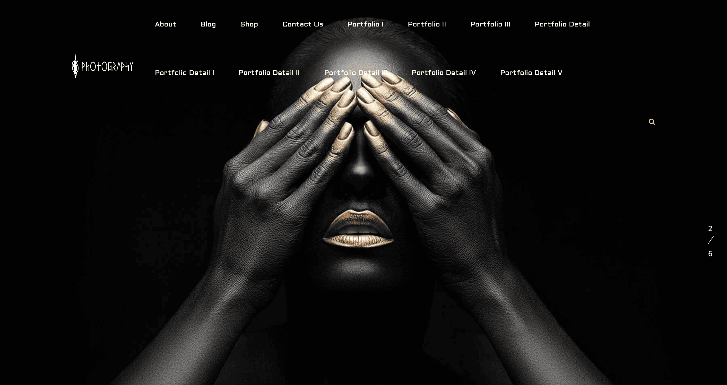 Person with black and gold makeup covers their eyes with their hands on a dark background.