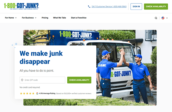 Two workers in blue uniforms high-five in front of a "1-800-GOT-JUNK?" truck. A search form to enter a ZIP code showcases why this local service company is highly rated, ensuring customers find the best service nearby.