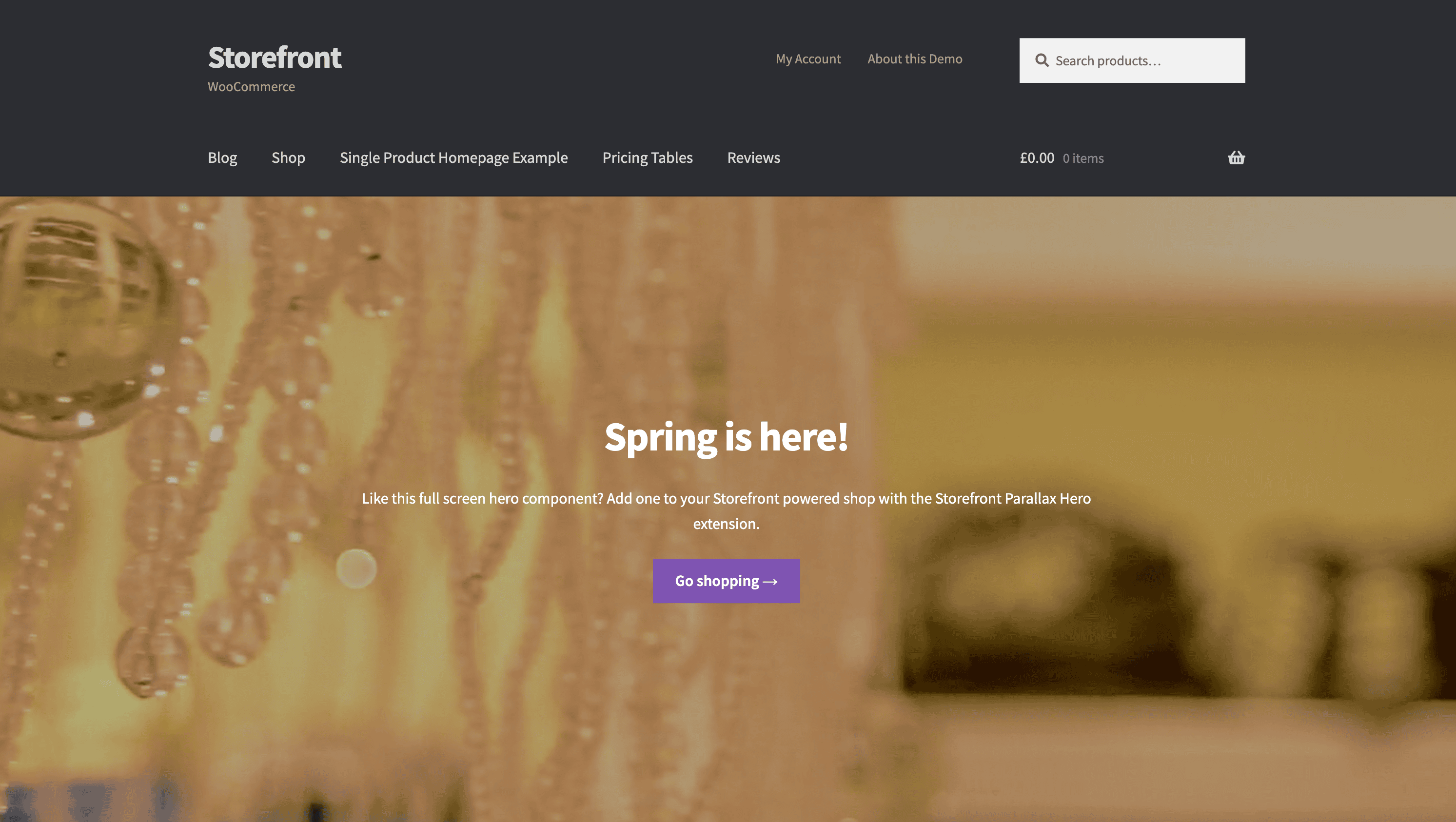 E-commerce homepage showing a "Spring is here!" message with a background of hanging decorations. A purple button invites users to go shopping.