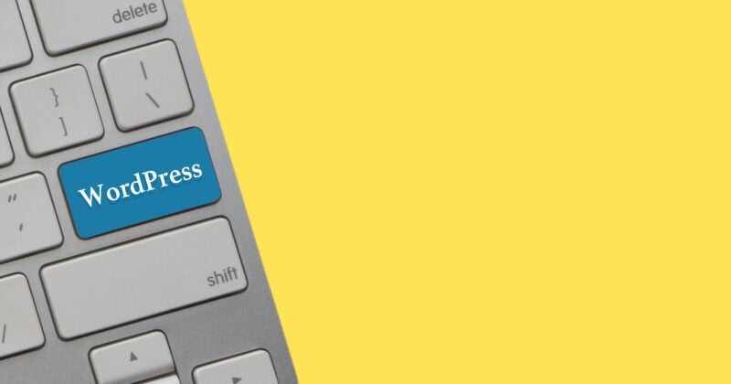 Close-up of a keyboard's corner featuring a blue "WordPress Affiliate" key, set against a vibrant yellow background.