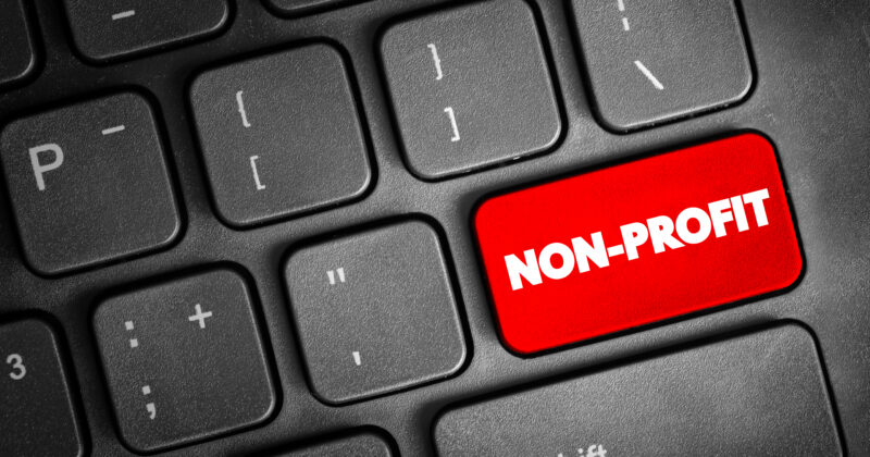 A close-up of a keyboard with a red key labeled "NON-PROFIT" among black keys.