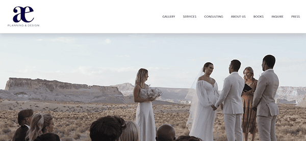 An outdoor wedding ceremony unfolds in a stunning desert landscape, featuring the bride, groom, officiant, bridesmaid, and guests. Inspiration for couples browsing wedding websites or seeking the best wedding planner for a unique celebration.